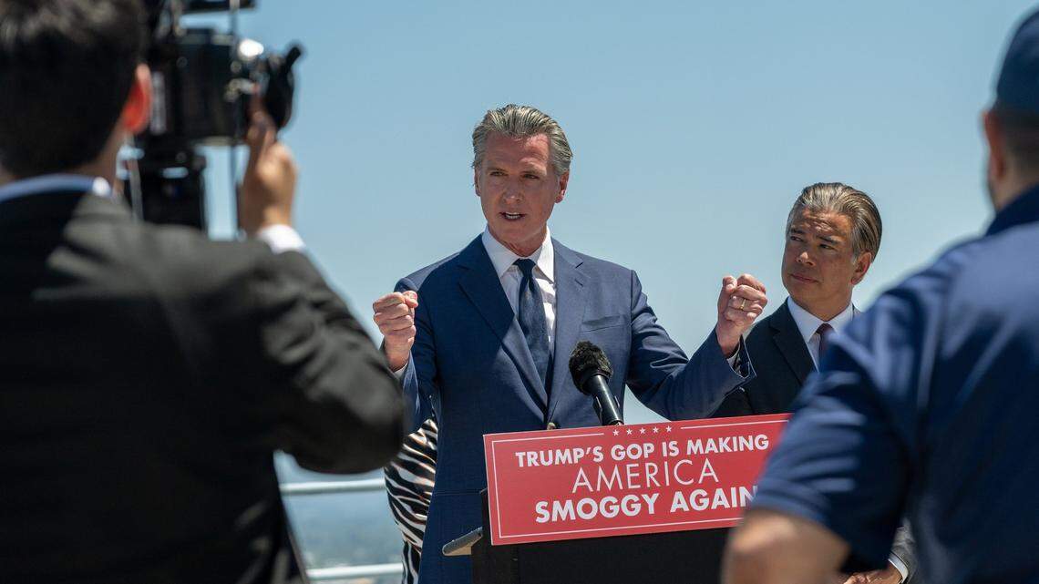 Gov. Gavin Newsom speaks as state Attorney General Rob Bonta listens during a press conference on the CalEPA building roof in Sacramento last month. The event followed their legal challenge to former President Donald Trump’s tariffs, which a federal judge dismissed this week on procedural grounds.