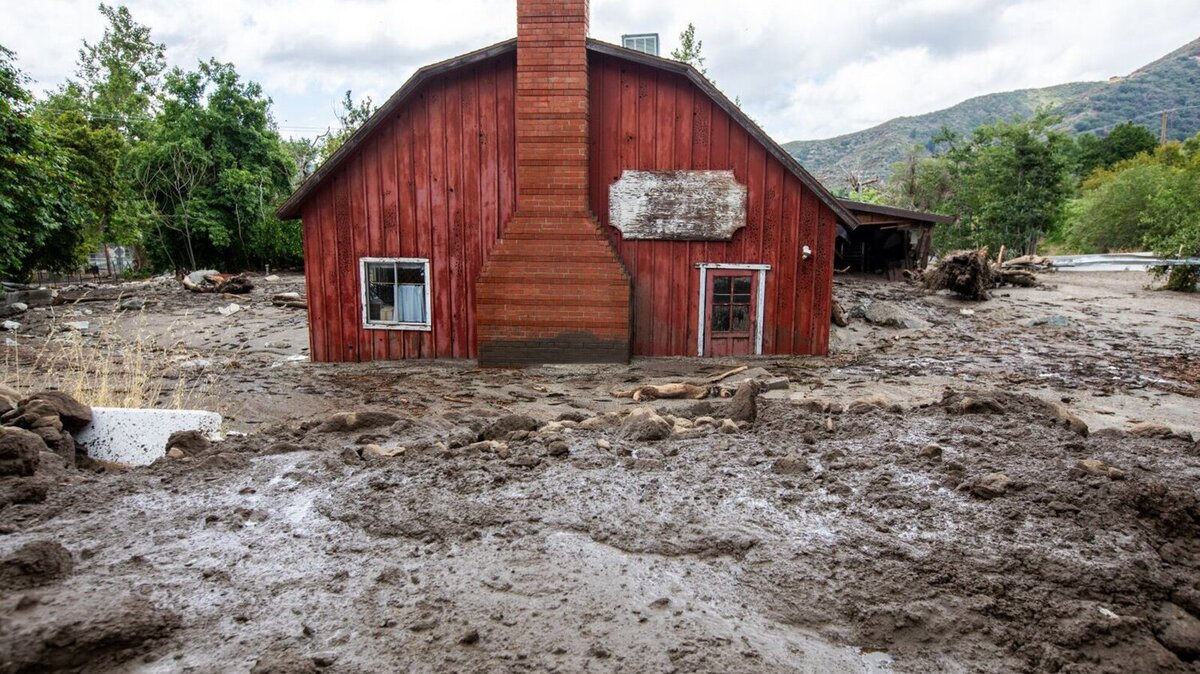 A red house in Oak Glen, Calif., is encased in deep mud after Tropical Storm Hilary in August.