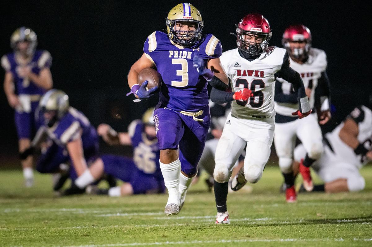 Bradshaw Christian fullback Mateo Mojica (3) breaks away from the line and runs toward a touchdown, as Delhi middle linebacker Antonio Gutierrez (36) pursues him, during the first half of the CIF Sac-Joaquin Section Division 6 high school football playoff game Friday, Nov. 4, 2022, at Bradshaw Christian School in Sacramento.