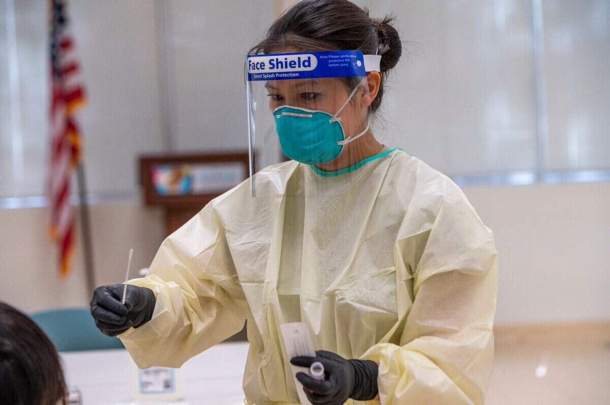 California National Guard Staff Sgt. Michiko Ima conducts a COVID-19 test inside a Natomas Unified School District building on Tuesday, July 14, 2020. The guard is helping reopen five community based testing sites in Sacramento County.