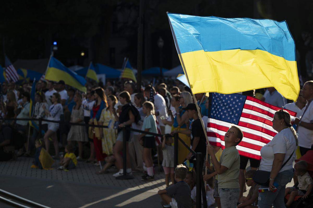 Ukrainian Americans wave Ukrainian and American flags during a Ukrainian Independence Day celebration at the California Capitol in Sacramento on Sunday.