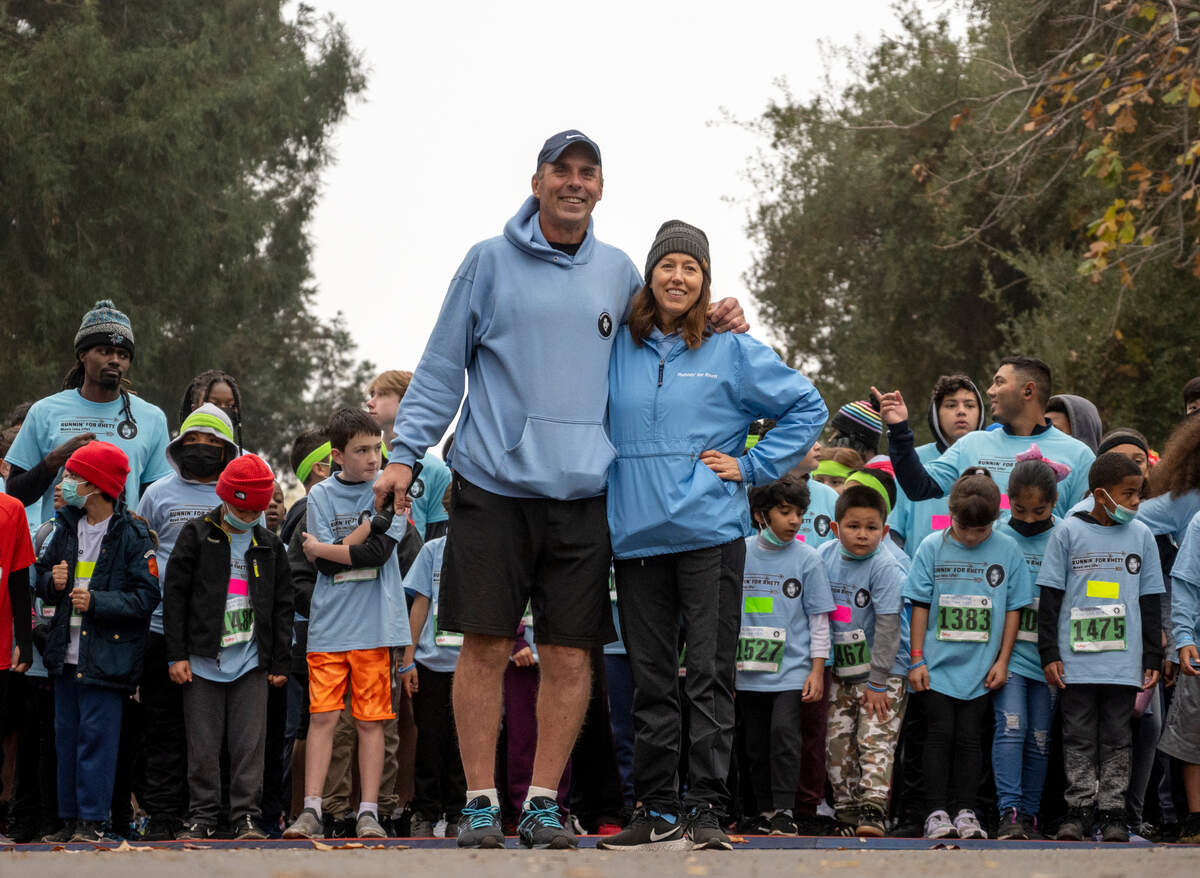 Randy and Beth Seevers, founders of Runnin’ for Rhett and parents of Rhett Seevers, stand together before the start of their Run Because You Can race on Dec. 4 at Crocker Park.