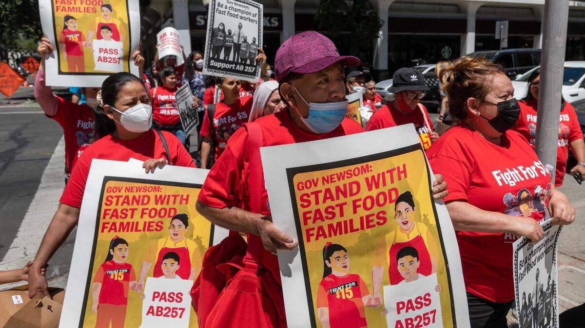 Fast food workers march from the SEIU headquarters in Sacramento on May 31, 2022, to deliver postcards to state legislative offices in support of AB 257, which would have provided more worker protections. It was sidelined by a voter referendum led by business groups.