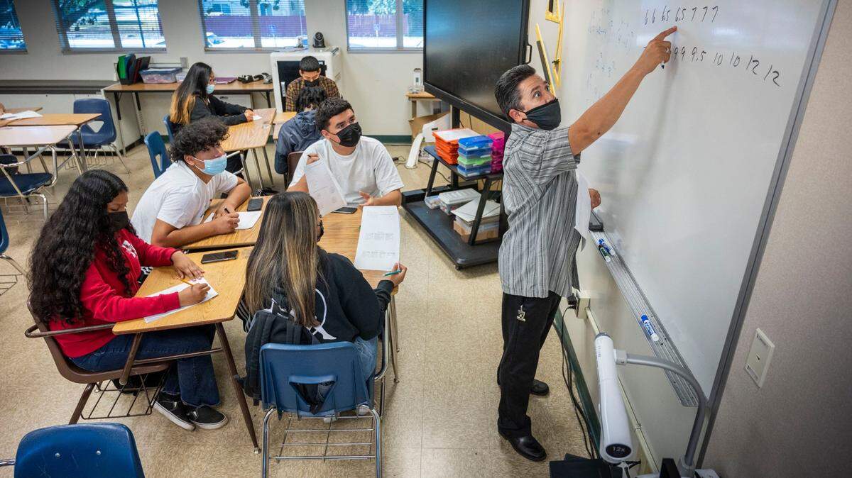 Math teacher Benito Dimas wears a mask as he instructs students in class at Hiram Johnson High School in Sacramento in June.