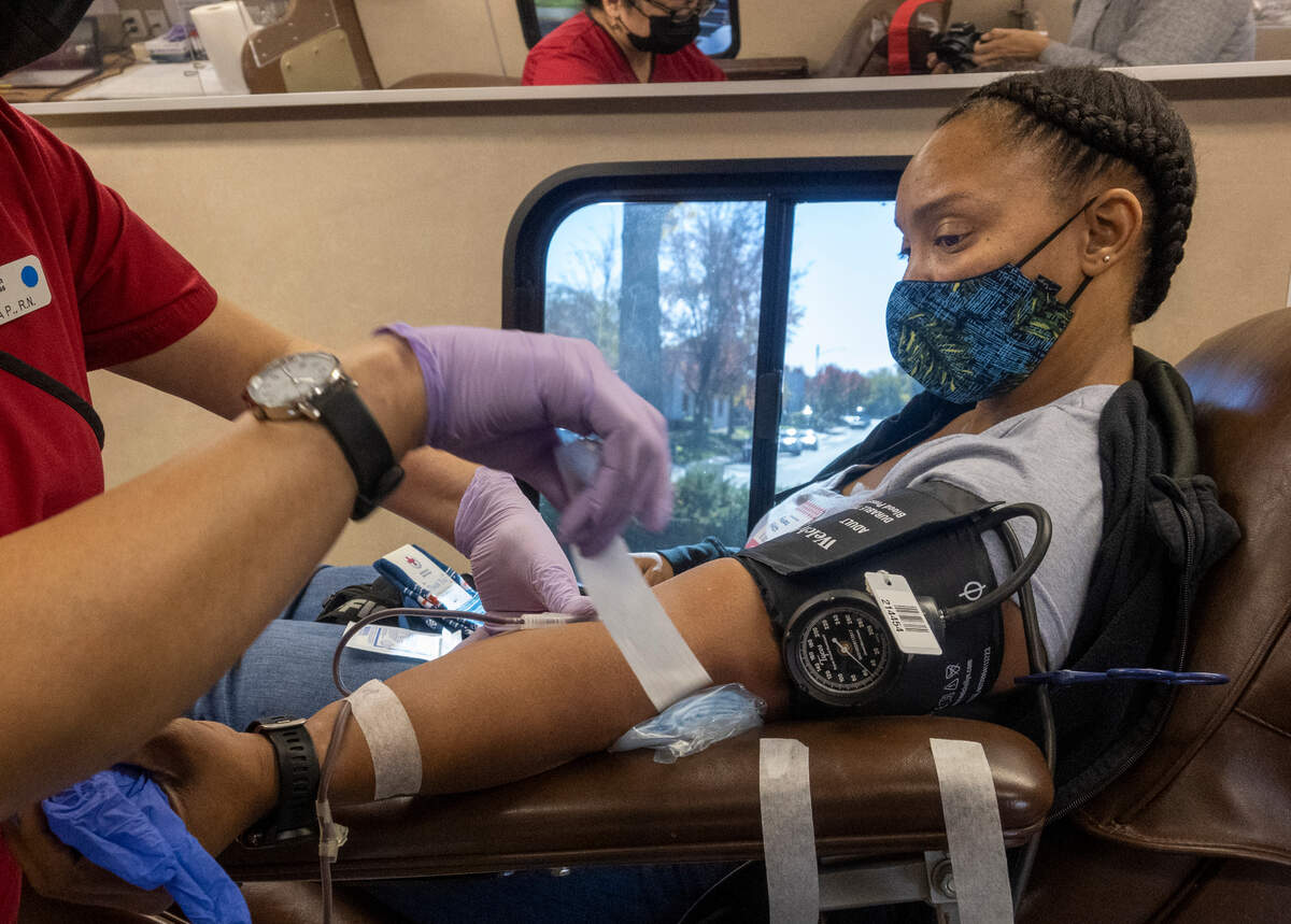 Stateworker Shavana Fisher donates blood at the Red Cross moble bus outside of the UC Davis Home Care Services building in Sacramento on Wednesday, Nov. 24. The Red Cross is asking for $7,700 to fund the in-depth testing, typing and matching of blood for people living with sickle cell disease.