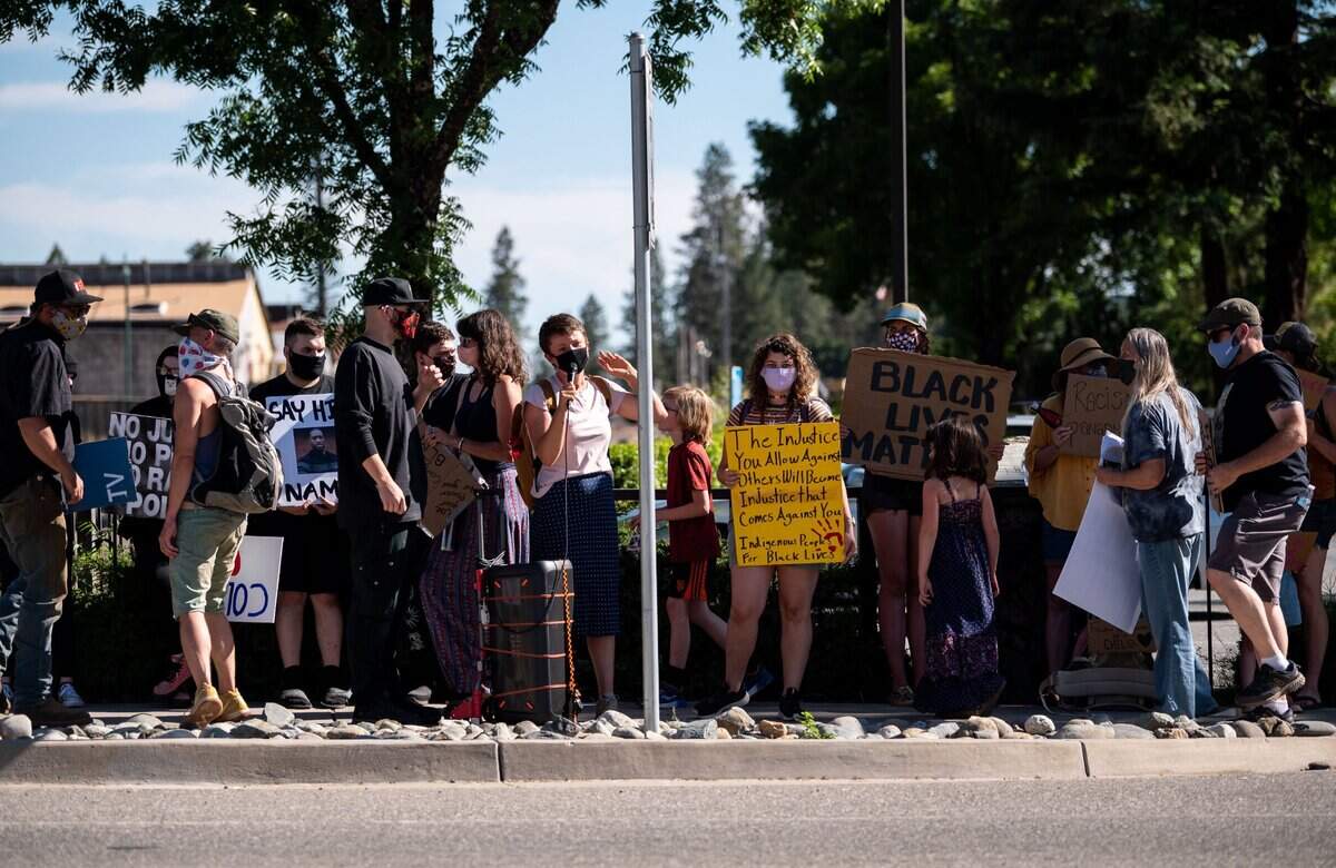 Bryanna Eisenhut, center, of Colfax, addresses the crowd of protesters Wednesday with Ariel Elliott, holding a yellow sign right of center.