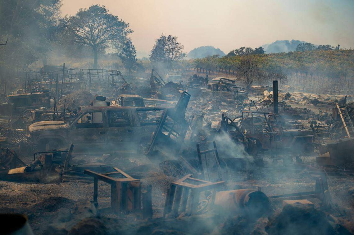 Smoke rises from the charred remains of a property on Chalk Hill Road in Healdsburg after the Kincade Fire passed through the neighborhood Sunday, Oct. 27, 2019.