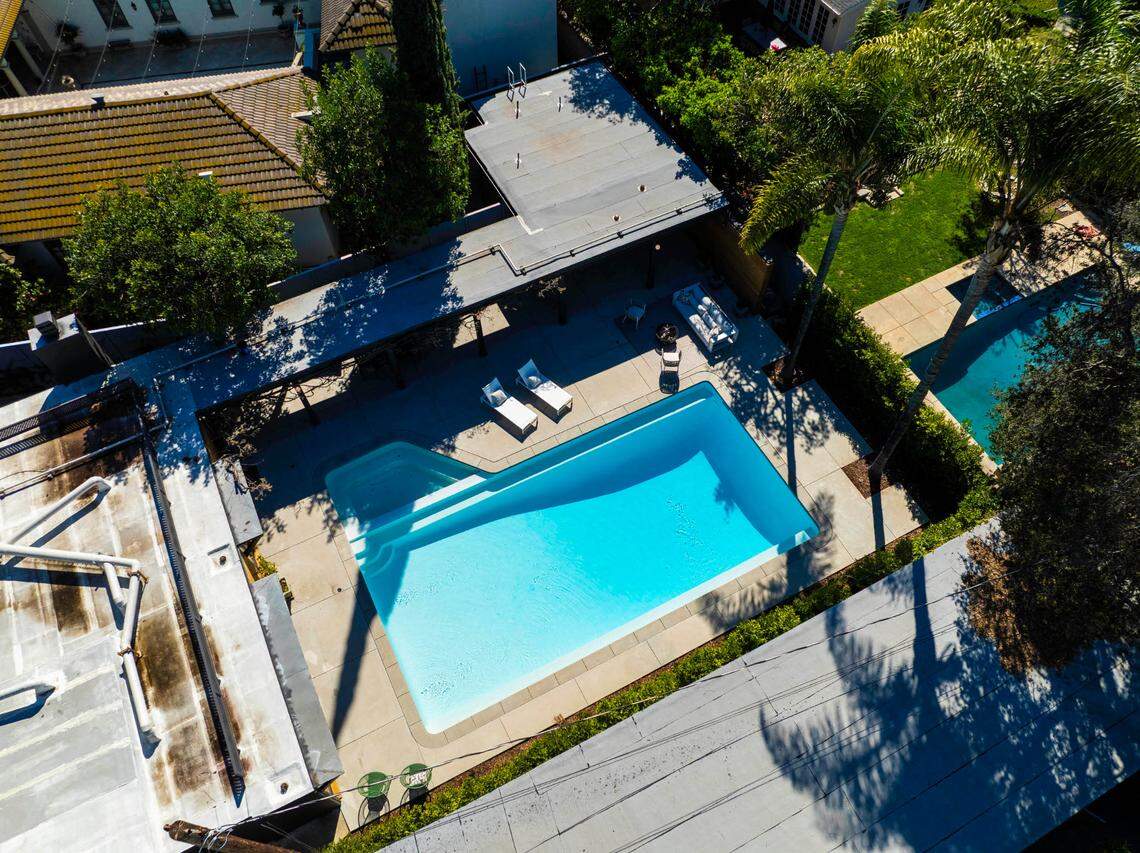 A resort-style backyard boasts a 10-foot-deep pool, spa and lush landscaping.