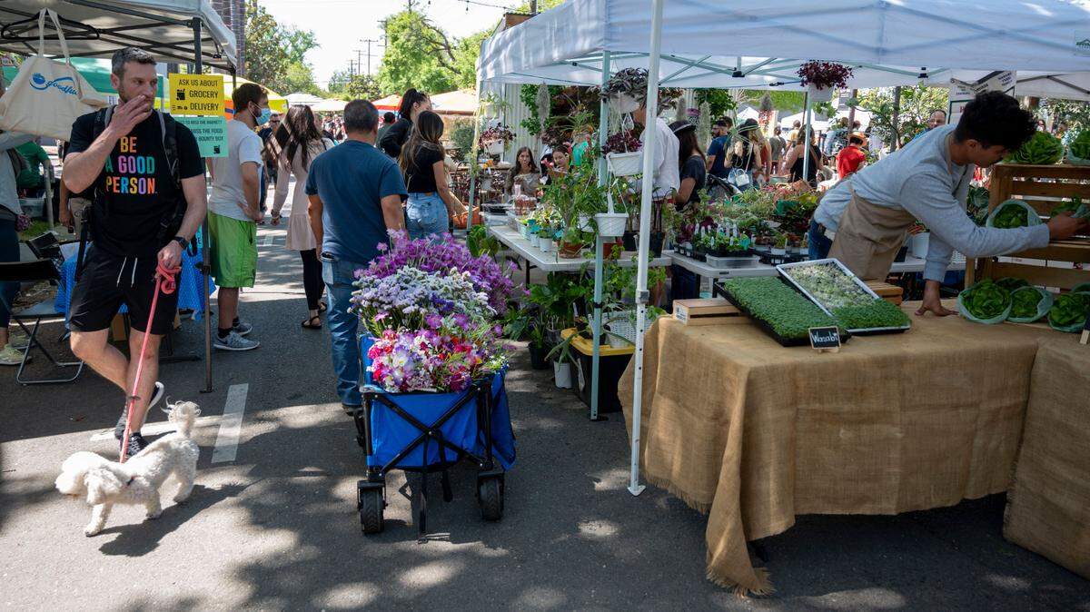 People shop at the Midtown Farmer’s Market on Saturday, April 30, 2022.