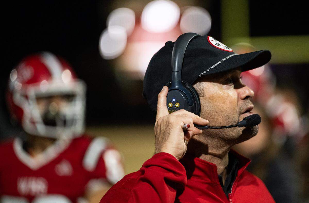 Winters Warriors coach Daniel Ward listens on his headset on the sideline in a CIF Northern California regional football championship game against the Arcata Tigers on Friday, Dec. 6, 2024, in Winters.