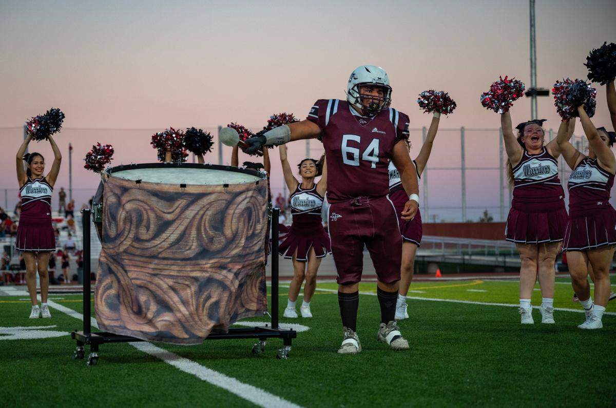 Hiram Johnson Warriors senior lineman Diego Ocana (64) pounds the drums for the inaugural “Warrior Drum Bang” on Friday before playing in the school’s first game in its newly renovated football stadium.