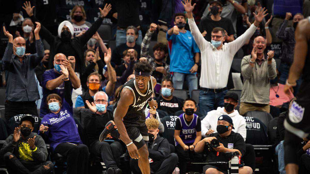 Sacramento Kings guard Terence Davis (3) is cheered by the crowd after a layup after a steal by guard Davion Mitchell (15) during the second period against the Utah Jazz at the NBA regular season home opener Friday, Oct. 22, 2021, at Golden 1 Center in downtown Sacramento.