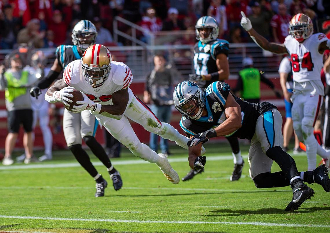 San Francisco 49ers running back Tevin Coleman (26) breaks tackle by Carolina Panthers strong safety Eric Reid (25) and dives into the end zone for touchdown in the first quarter during a game at Levi’s Stadium on Sunday, October 27, 2019 in Santa Clara.