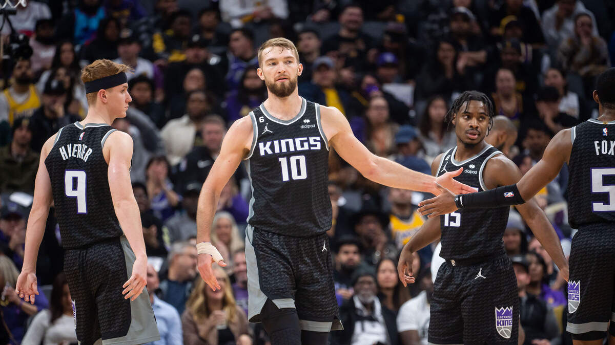 Sacramento Kings center Domantas Sabonis (10) is congratulated by teammates after scoring and collecting a foul from the Los Angeles Lakers during the second quarter of the NBA basketball game Saturday, Jan. 7, 2023, at Golden 1 Center in Sacramento.