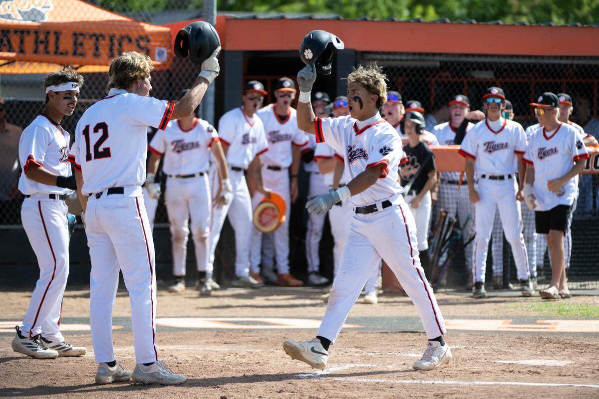 The Roseville Tigers’ Benjamin Jordan celebrates with Justin Fischer after his two-run home run against the East Union Lancers in the CIF Sac-Joaquin Section baseball playoffs at Roseville High School on Tuesday in Roseville.