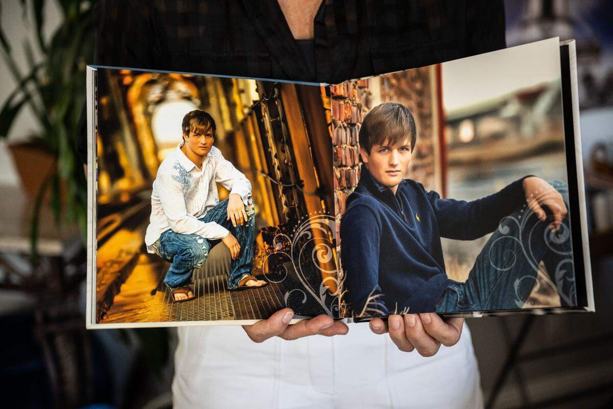 Deanna Hampton of Auburn holds a book in July with photos of her late son Trevor, who was abused by Father Michael Kelly while serving as an altar boy at the Mokelumne Hill Church in San Andreas.
