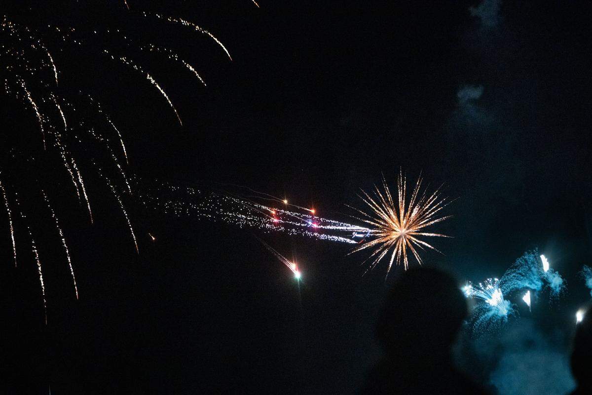 A plane releases sparks while flying amidst fireworks during the California Capital Airshow’s closing performance at Mather Airport near Rancho Cordova on Saturday, July 13, 2024. The final display of the show also featured illustrations created by nearly 500 drones.