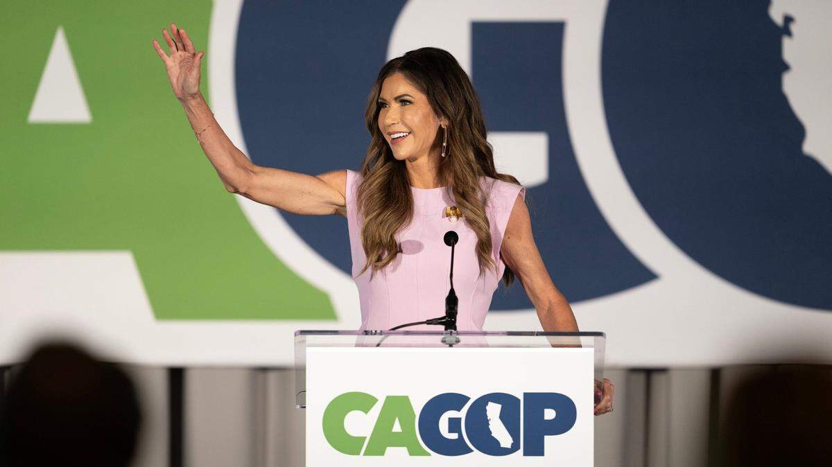 South Dakota Gov. Kristi Noem waves to supporters after her introduction at the CAGOP Convention on Saturday at the Hyatt Regency Airport hotel in Burlingame.