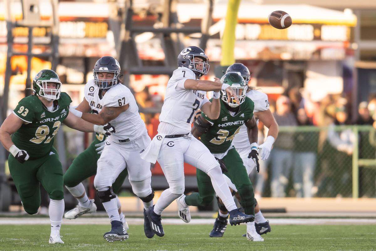 UC Davis Aggies quarterback Miles Hastings (7) passes under pressure during the third quarter at the Causeway Classic on Saturday at Hornets Stadium. Hastings was a first-team selection to the All-Big Sky team.