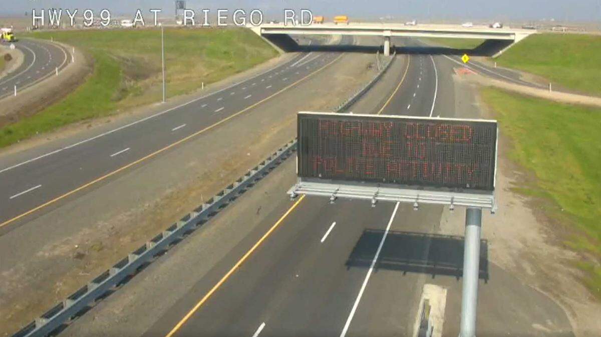 An image taken from a Caltrans traffic camera Tuesday, Nov. 23, 2021, shows northbound Highway 99 just before Riego Road empty, and a freeway sign that says the road is closed due to “police activity.”