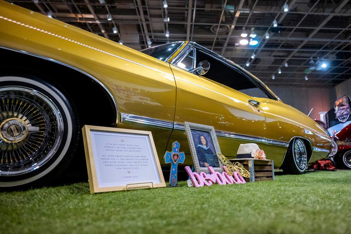 A 1967 Chevy Impala Fastback lowrider owned by Adrianna Echeverria displayed in the California State Fair’s lowrider exhibit on July 9, 2025. Echeverria, an elementary school teacher displays her masters graduation portrait form Concordia University next to the Impala.