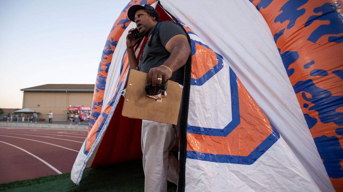 Cosumnes Oaks Wolfpack coach Martin Billings prepares to lead his varsity football team onto the field in September 2022 in Elk Grove. Billings announced early in the 2024 season that amyotrophic lateral sclerosis, also known as ALS, and the team has dedicated its efforts this year to him.