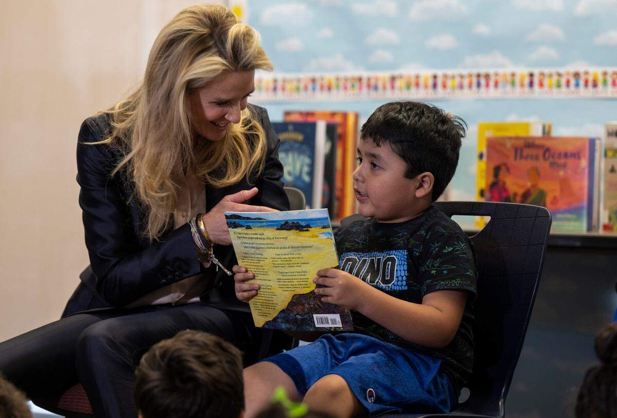California First Partner Jennifer Siebel Newsom gives a bilingual storybook to Jose Maria Anguiano after reading it to him and other children Tuesday, June 6, 2023, at the Arthur F. Turner Community Library in West Sacramento.