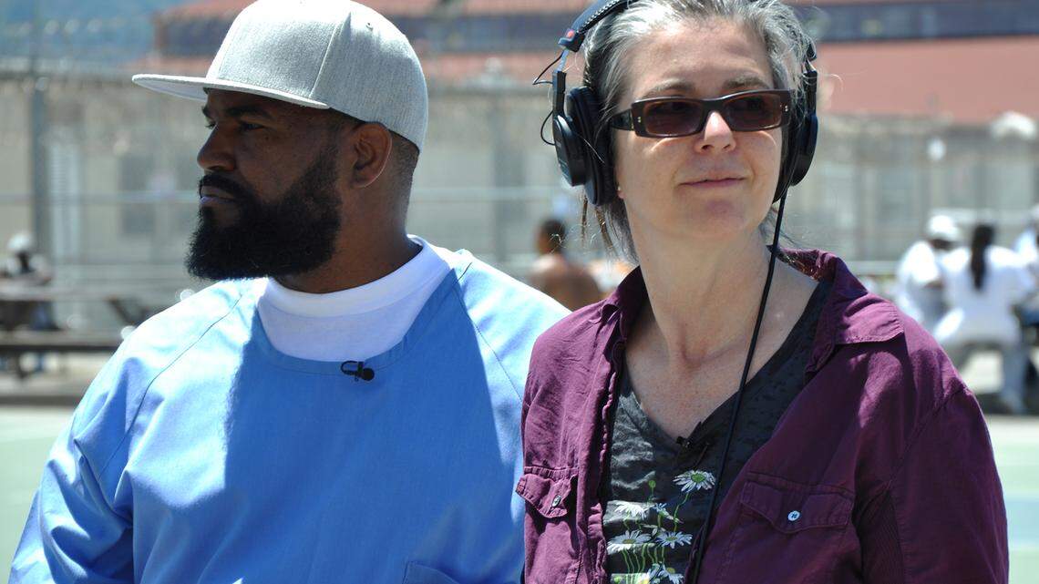 Sacramento State photography professor Nigel Poor, right, and Earlonne Woods work on “Ear Hustle” at San Quentin.
