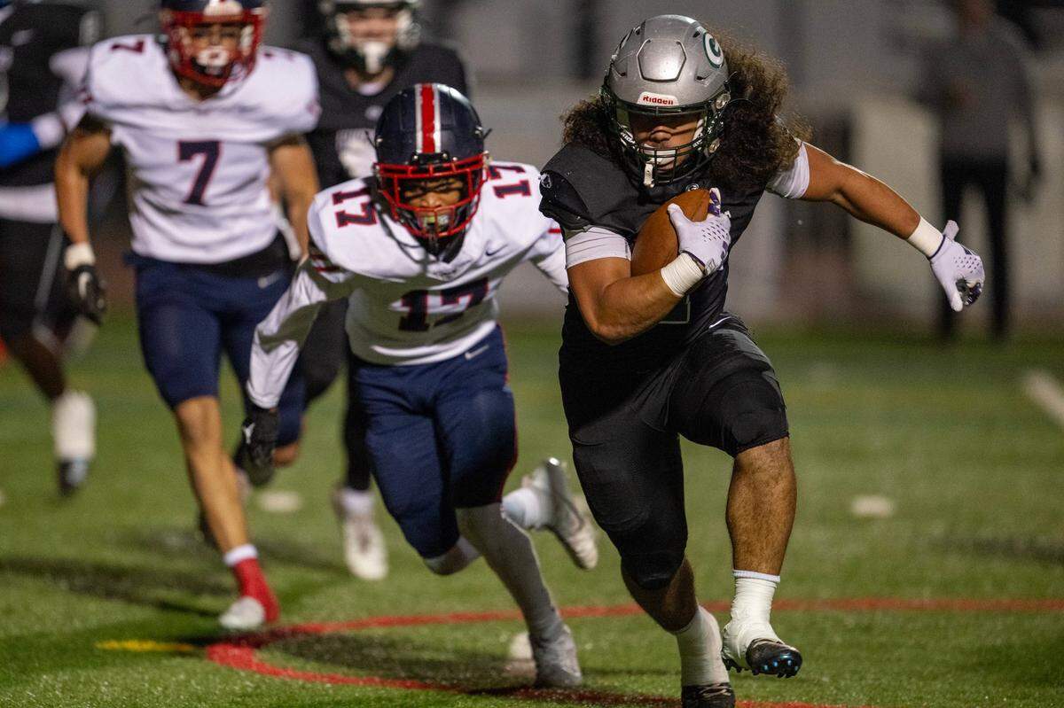 Granite Bay Grizzlies’ running back Isaiah Ene (1) runs past Pleasant Grove Eagles cornerback Pharrell Williams (17) for a touchdown in the first half a Sac-Joaquin Section first-round playoff game Friday, Nov. 8, 2024 in Granite Bay.
