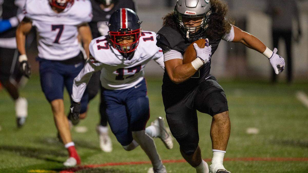 Granite Bay Grizzlies running back Isaiah Ene (1) escapes Pleasant Grove Eagles defenders for a touchdown in a Sac-Joaquin Section first-round playoff game in November. Ene has pledged to join Sacramento State’s football team.