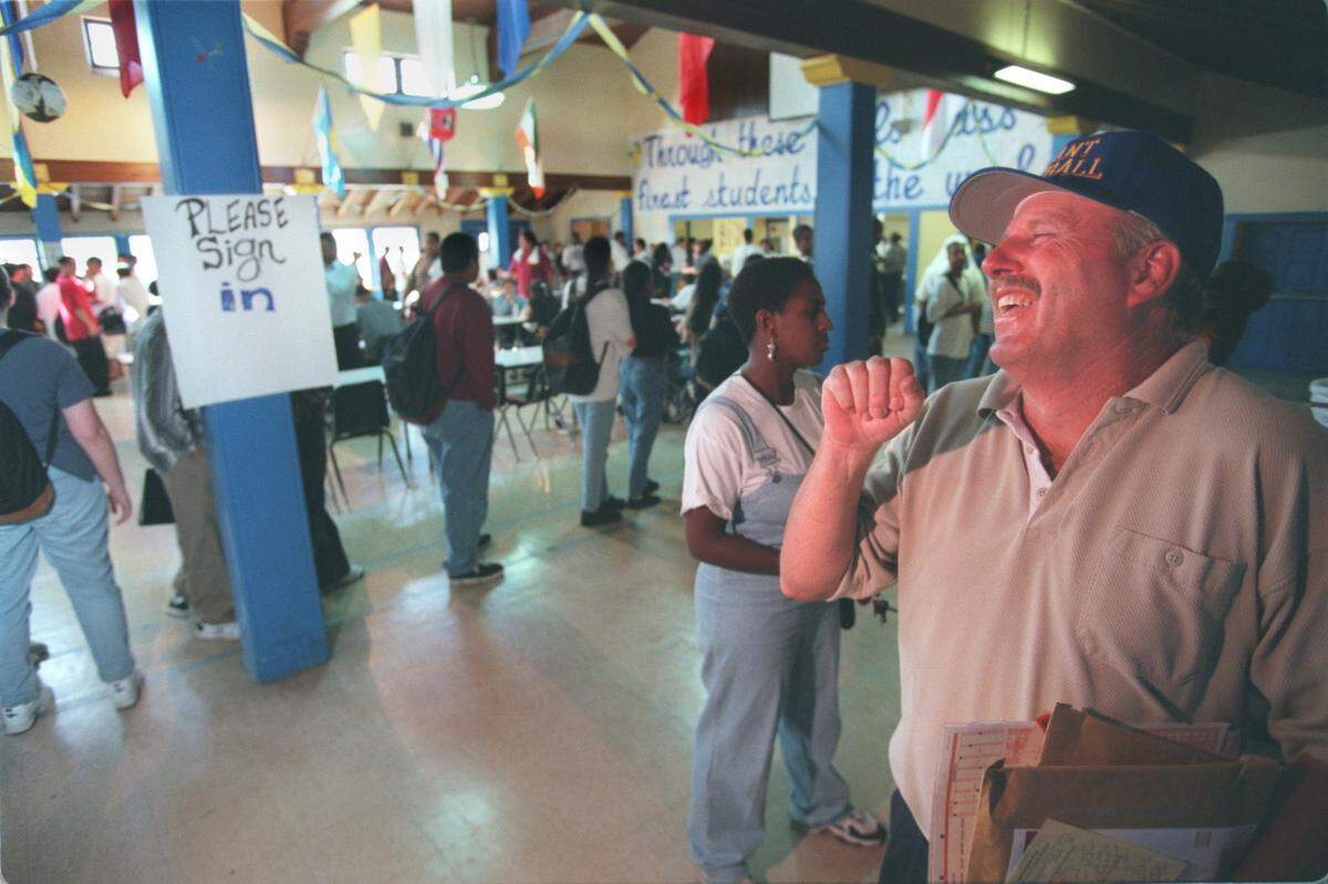 Mike Alberghini, athletic director at Grant High School, laughs as one of his students jokes around with him in the cafeteria at Grant High School during lunch in 1997.