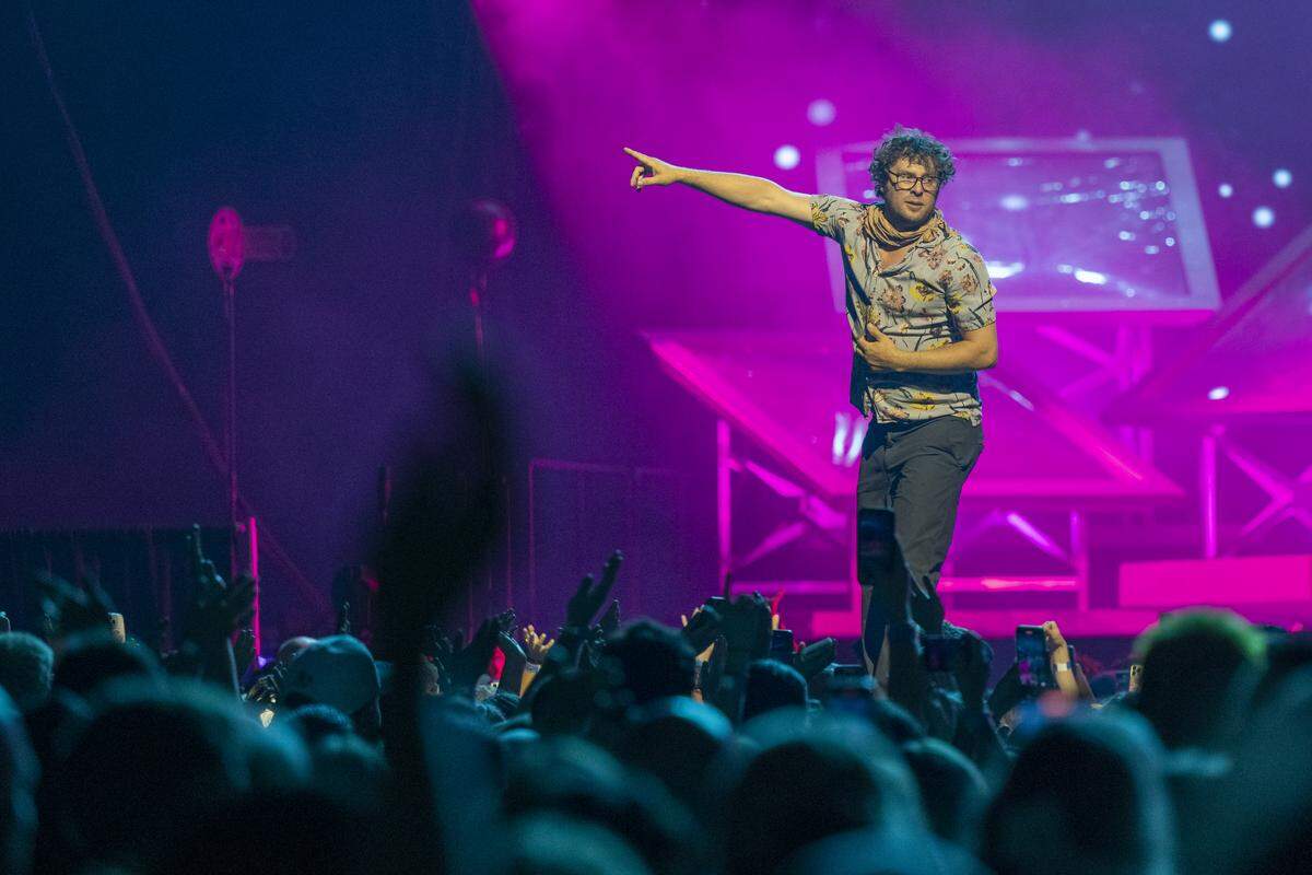 Stelth Ulvang, usually on piano for The Lumineers, points to the crowd during the performance of “A.M. Radio” at  Golden 1 Center in downtown Sacramento on Wednesday.
