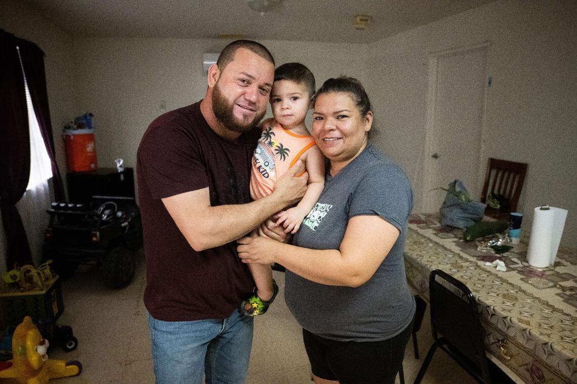 Juan Manuel Chapa and his wife Jessica Vela hold their son Jannick Dariel Chapa at their apartment at the Williams Migrant Center in July.