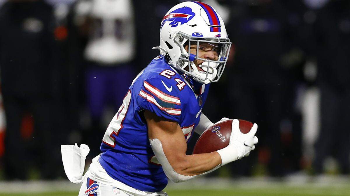 Buffalo Bills cornerback Taron Johnson runs back an interception for a touchdown during the 2021 playoffs.