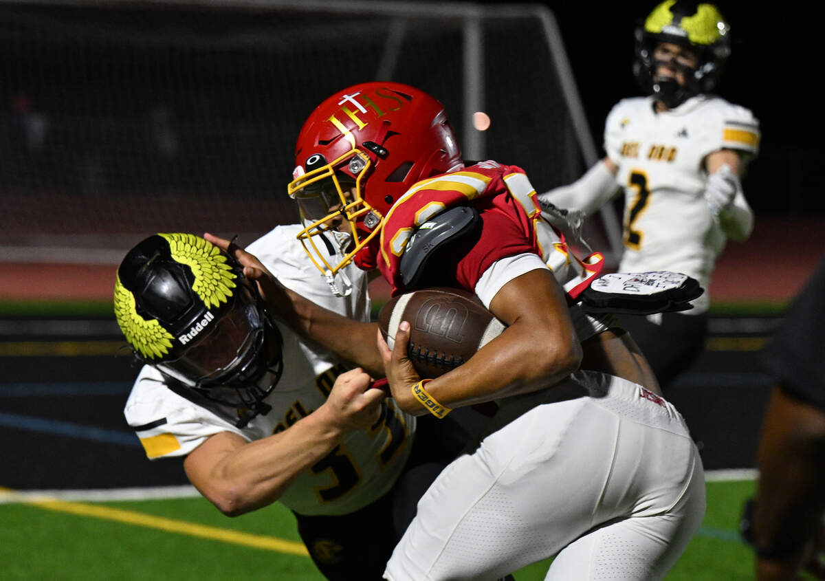 The Jesuit Marauders' Kwanna Smith (23) pushes Del Oro's Evan Hilmen (33) after catching a pass in the first half on Friday, Oct. 17, 2025, in Carmichael.