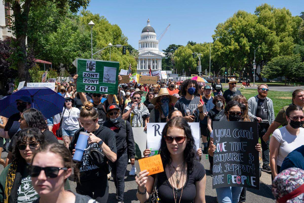 Demonstrators march past the state Capitol to the U.S. Immigration and Customs Enforcement office in downtown Sacramento on Monday.