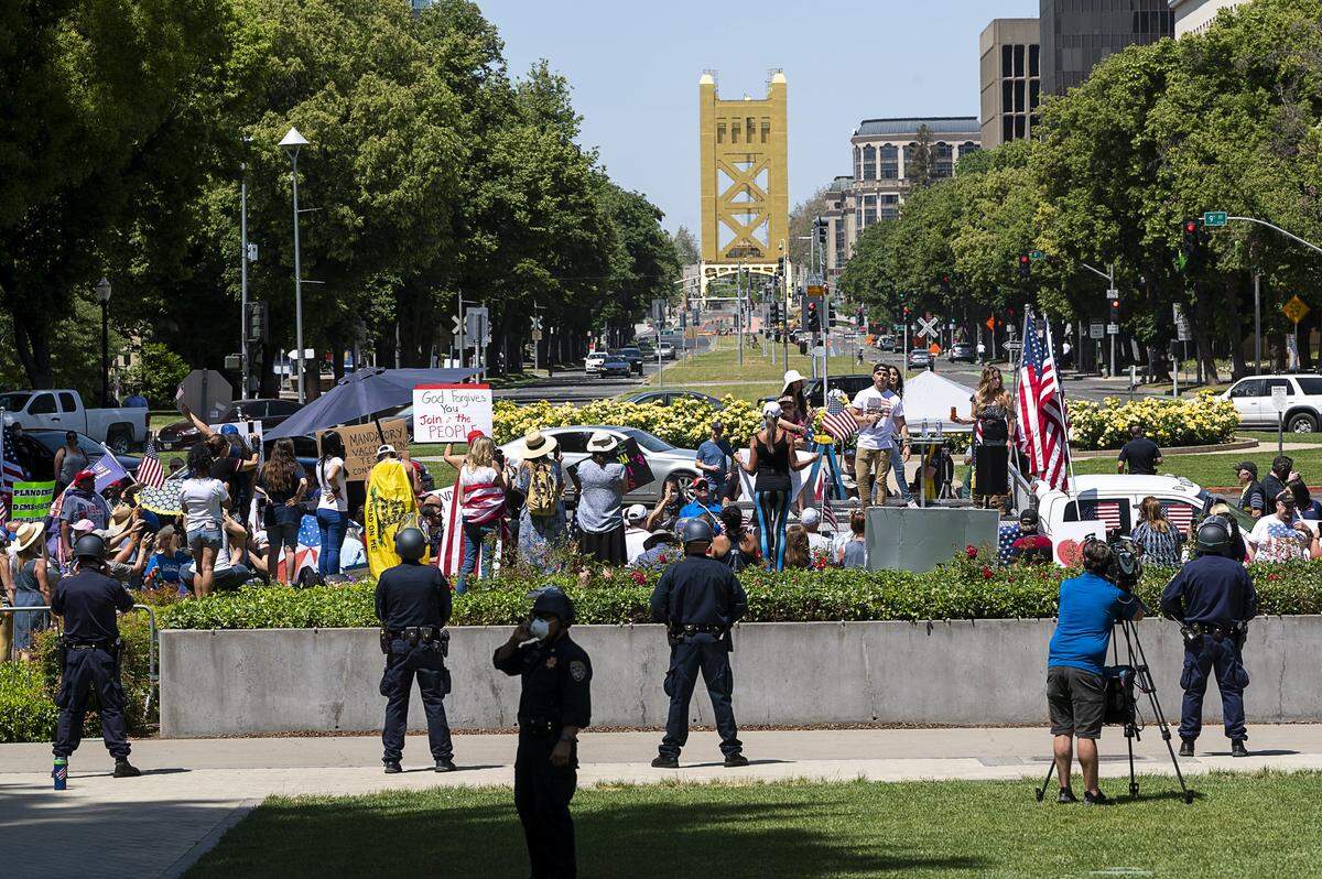 California Highway Patrol officers guard the state Capitol grounds during a protest against Gov. Gavin Newsom on Thursday, May 6, 2020 in Sacramento during the coronavirus pandemic.