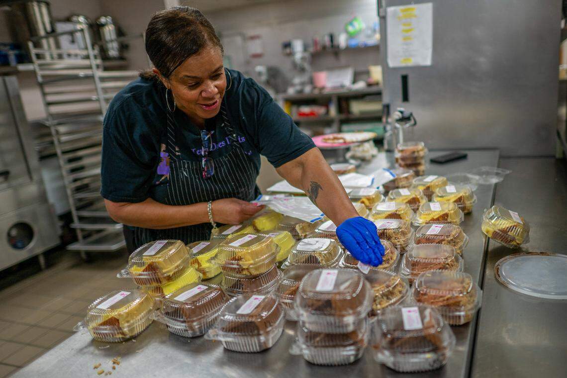 Terri Littleton, 63, a self-employed owner of Terri Does Desserts, places ingredient labels on containers after adding slices of a cake she made earlier on Wednesday, April 1, 2026, in Sacramento. The baker struggles to pay for her health insurance, which has increased from $255 to $555, she said. “When they ended the subsidy, they said it would go up $100,” said Littleton, who now pays with her credit card but says it is very challenging.