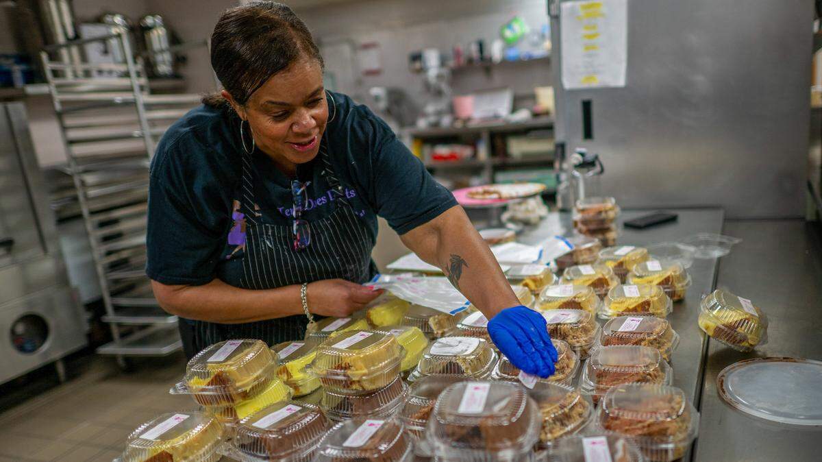 Terri Littleton, 63, a self-employed owner of Terri Does Desserts, places ingredient labels on containers after adding slices of a cake she made earlier on Wednesday, April 1, 2026, in Sacramento. The COMPETE Act targets single-company dominance that squeezes suppliers and workers, helping California small businesses survive and consumers pay less.