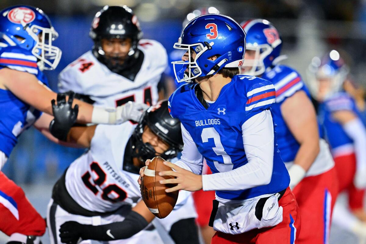 Folsom Bulldogs quarterback Ryder Lyons (3) runs the ball for a first down in the first half of the CIF Northern California Division 1-A championship against the Pittsburg Pirates on Saturday, Dec. 2, 2023, at Folsom High School.