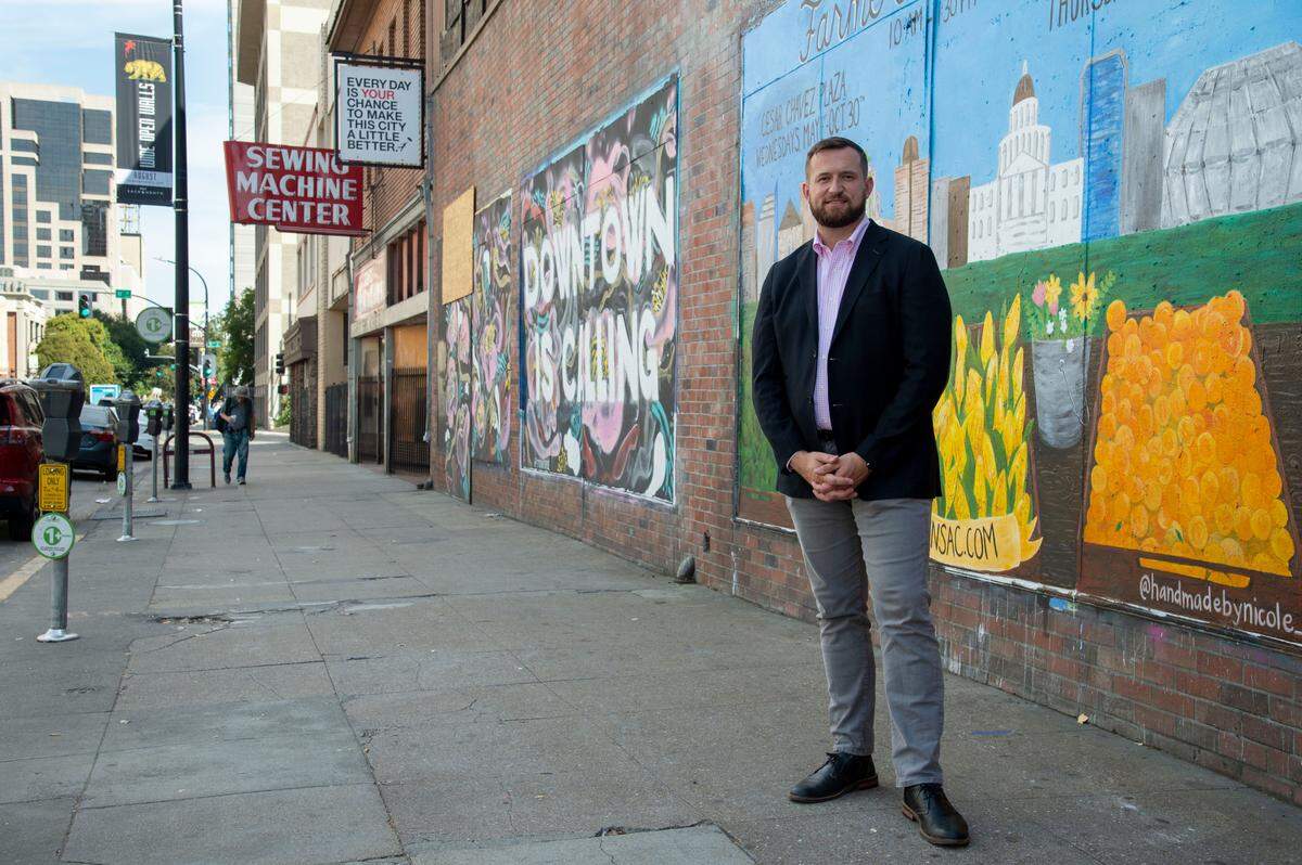 Sacramento City Councilmember Steve Hansen stands on J Street, Aug. 21, 2019, where he said a plan has been submitted to build an eight-story apartment building. Despite pockets of renewal in other spots of downtown, this block on J Street between 10th and 11th Streets sit vacant.