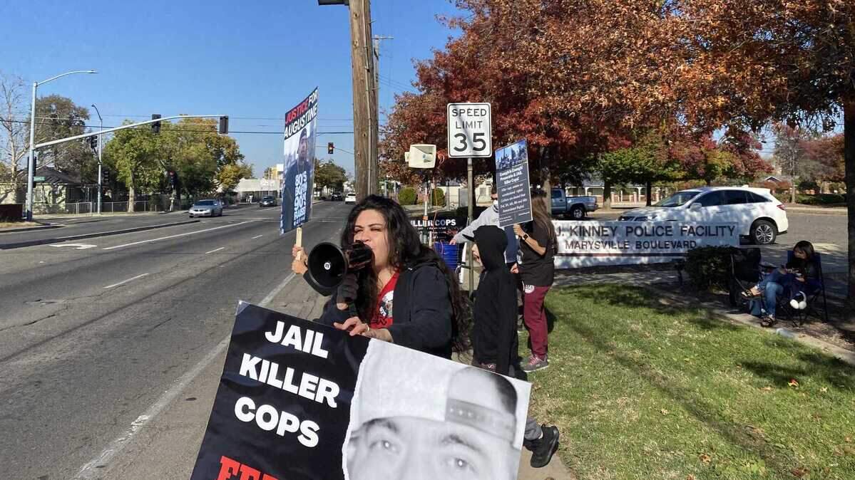 Seselie Morales speaks through a megaphone at drivers on Monday, Nov. 14, 2022, during a protest to call attention to the death of her father, Augustine Morales, who was shot by police outside a boxing event in November 2020 in Sacramento, Callifornia.