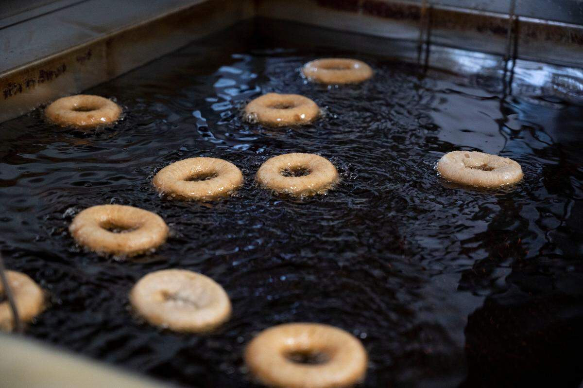 A fresh batch of sugar-coated apple cider doughnuts are fried at Rainbow Orchards on Nov. 17 in Camino.