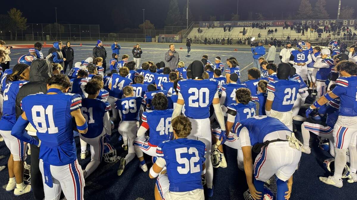 The Folsom Bulldogs huddle postgame after defeating the Downey Knights of Modesto 68-28 on Friday in Folsom.