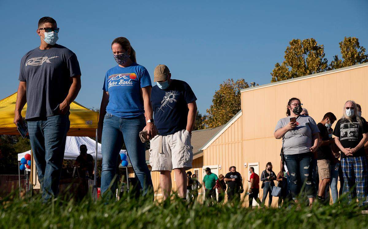 A long line of voters wait about 45 minutes to vote at the South Natomas Library on election day, Tuesday, Nov 3, 2020 in Sacramento.