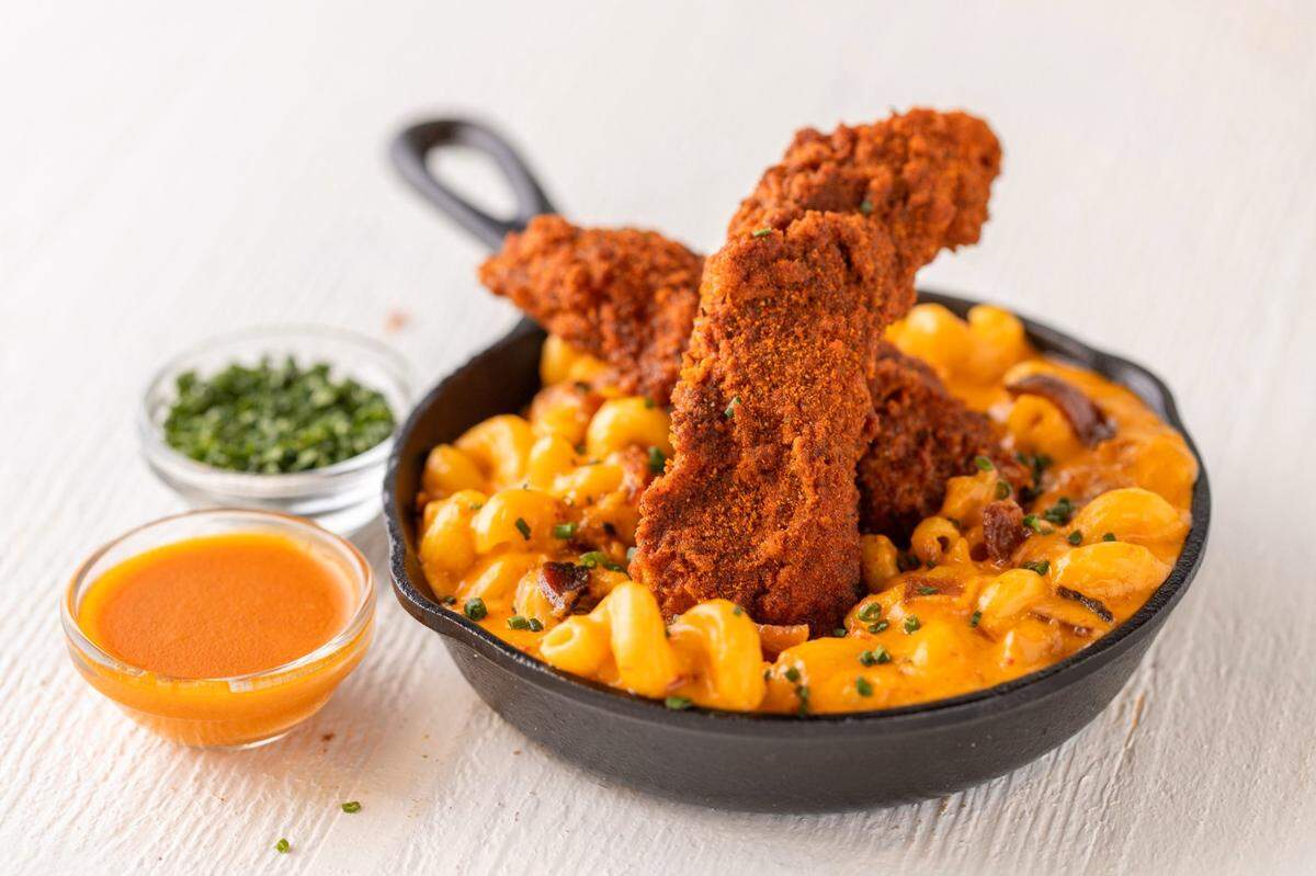 Bruxie’s Angry Bacon, Mac & Cheese entree is topped with spiced cheese sauce, applewood smoked bacon and chives.