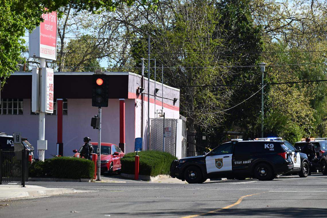 Sacramento Police officers respond to an incident at the Oak Park Market in south Oak Park on Thursday.