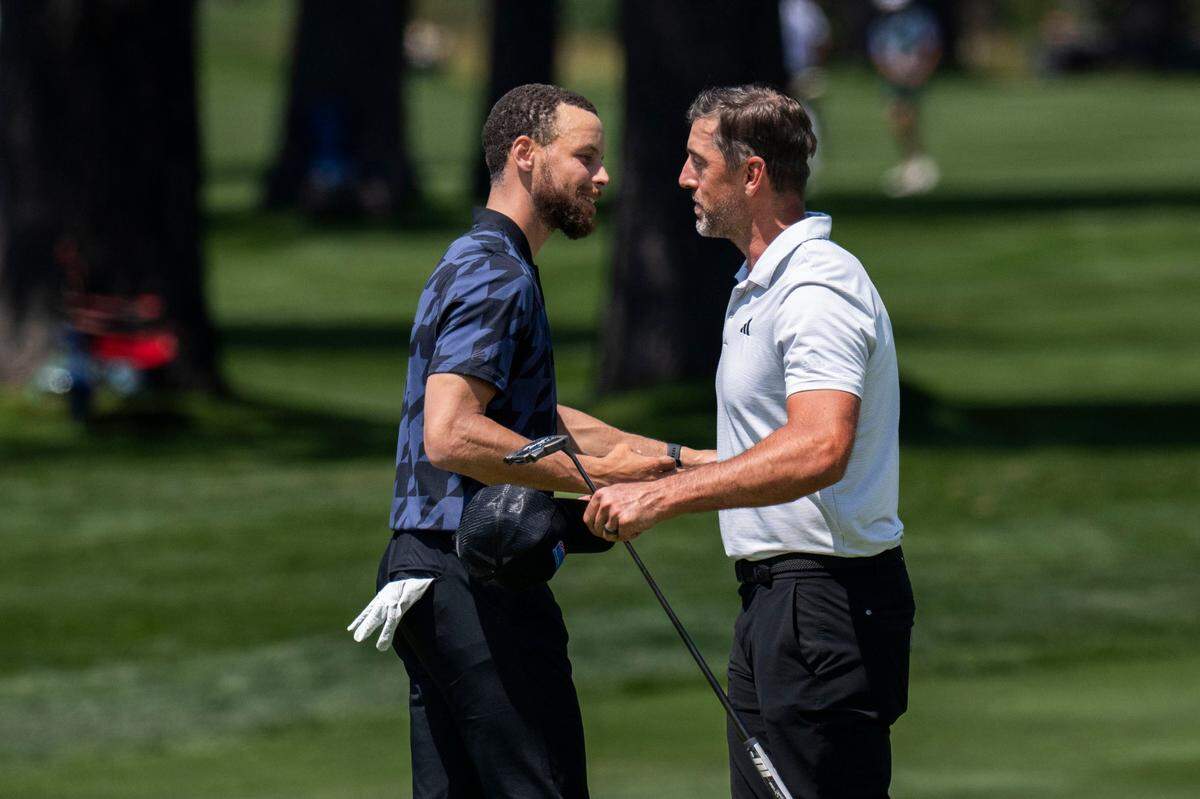 The Golden State Warriors’ Stephen Curry hugs NFL quarterback Aaron Rodgers after they participated in the final day of the American Century Championship celebrity golf tournament at Edgewood Tahoe Resort in Stateline, Nev., on Sunday, July 13, 2025.
