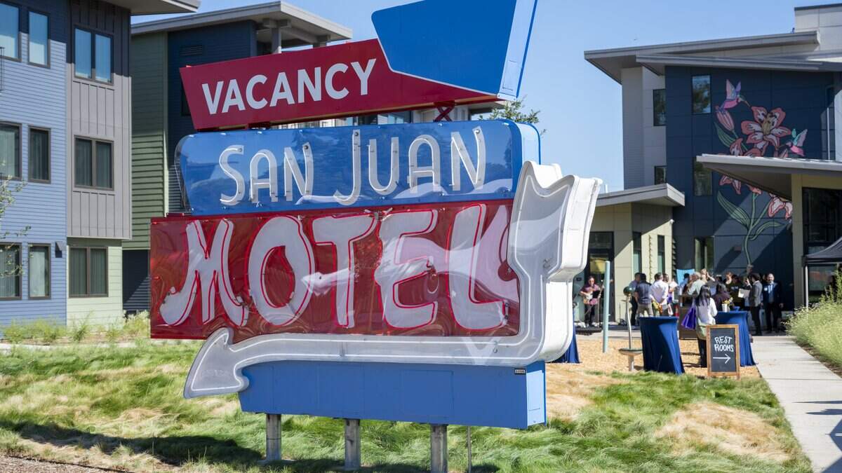 The historic San Juan Hotel sign stands outside the San Juan Apartments on the former motel property in south Sacramento on Tuesday. The new development has 113 units, with more to come. 