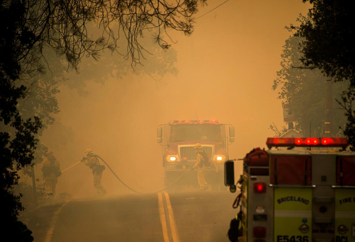 Firefighters work to contain the Pawnee fire on Sunday in Spring Valley in Lake County.